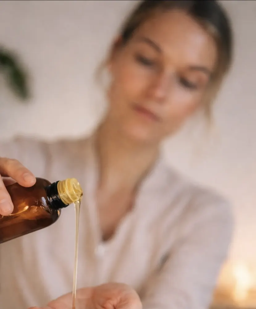 Tabea, preparing warm oil for a treatment